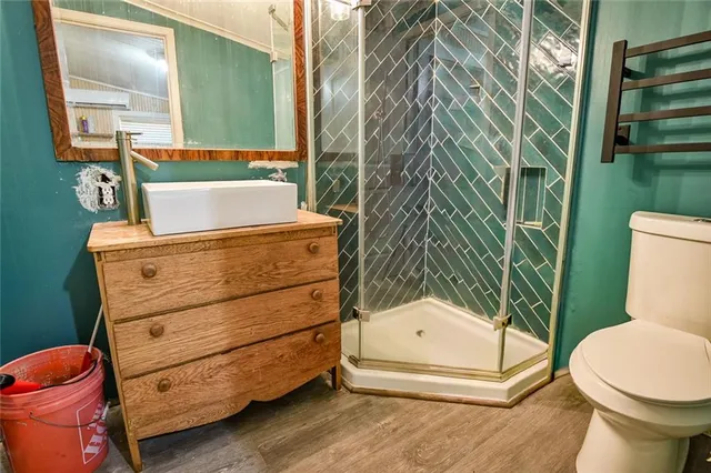 a bathroom with a sink a toilet and a mirror