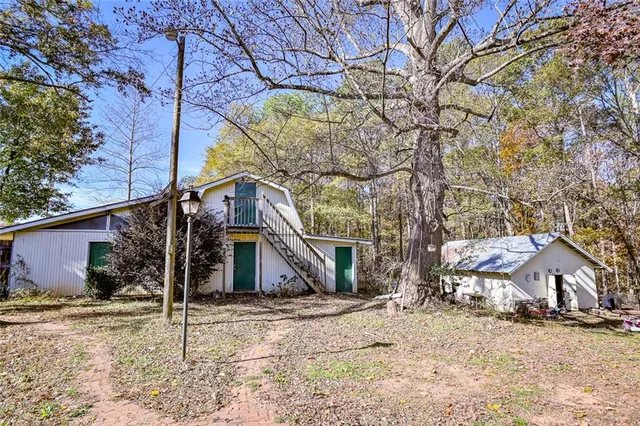 a view of a house with a yard covered in snow
