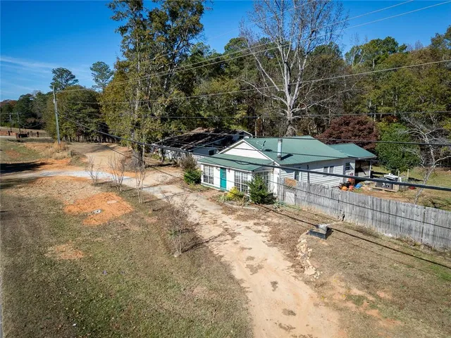 a view of patio with a table and chairs under an umbrella