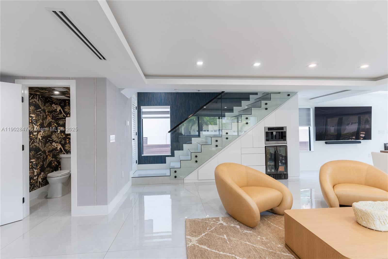 5601 North Ocean Drive Hollywood, FL 33019 - Photo 15 of 78 a living room with furniture and a flat screen tv