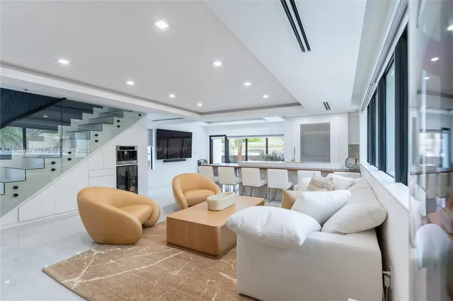 a bedroom with a large bed and wooden floor