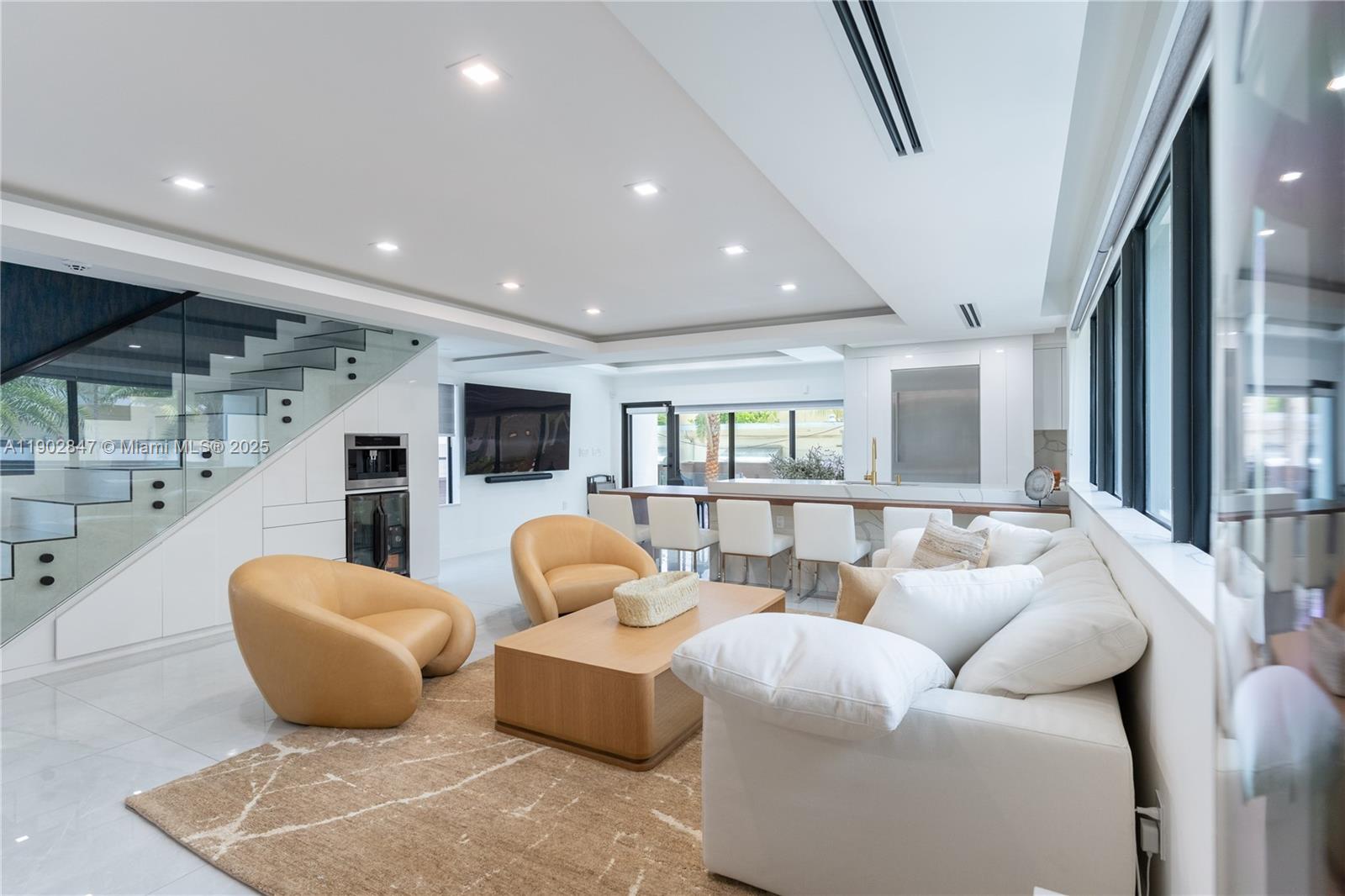 5601 North Ocean Drive Hollywood, FL 33019 - Photo 16 of 78 a living room with furniture a flat screen tv and a large window