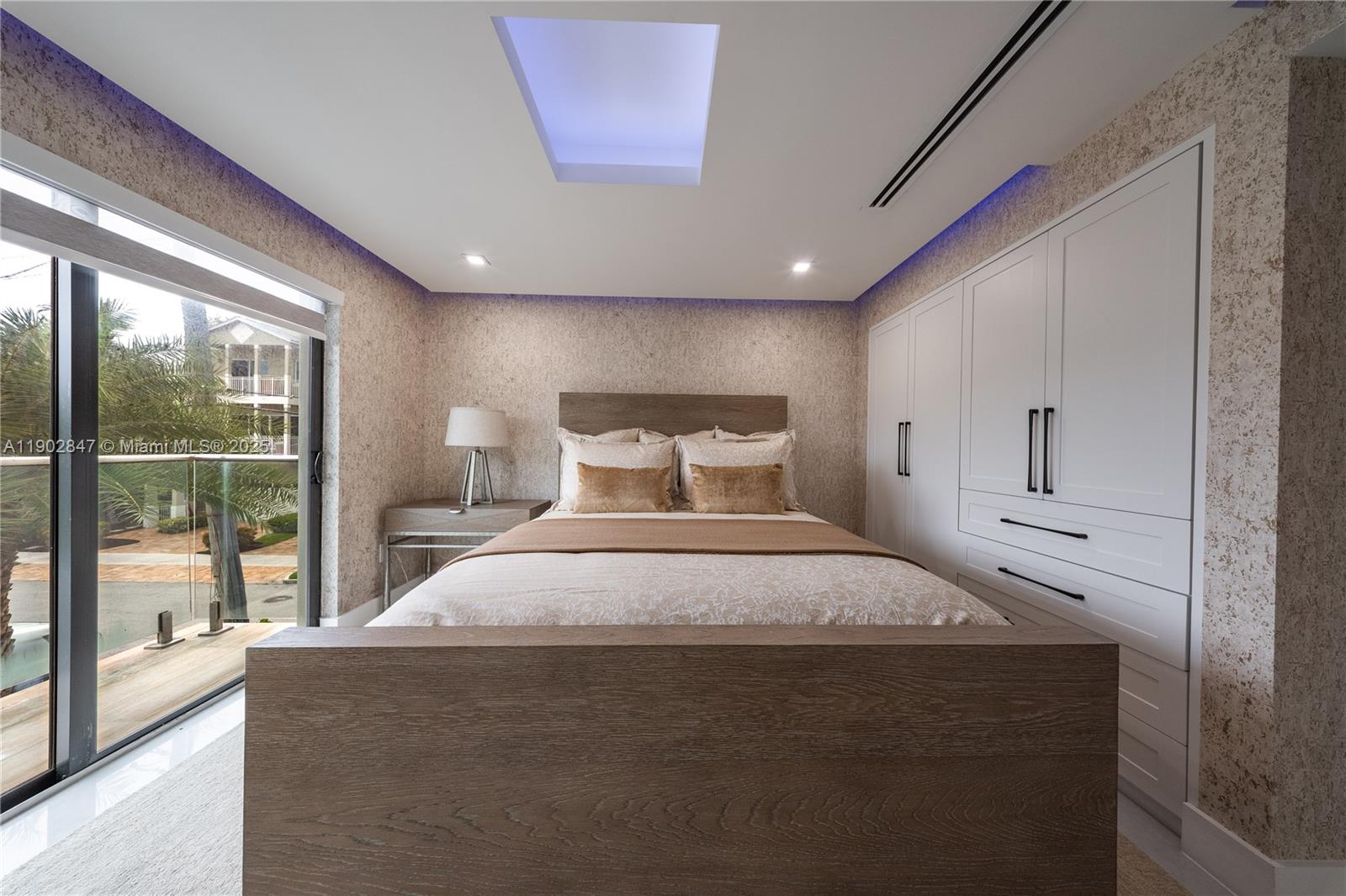 5601 North Ocean Drive Hollywood, FL 33019 - Photo 23 of 78 a bedroom with a large bed and wooden floor