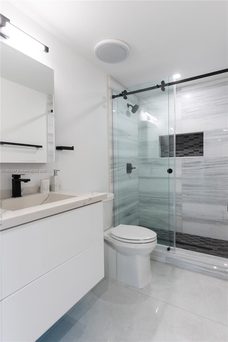 5601 North Ocean Drive Hollywood, FL 33019 - Photo 26 of 78 a bathroom with a sink a toilet and shower