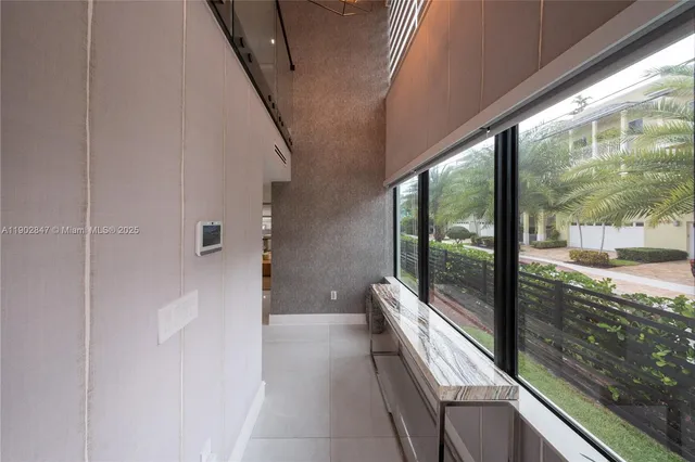 a large white kitchen with a large window