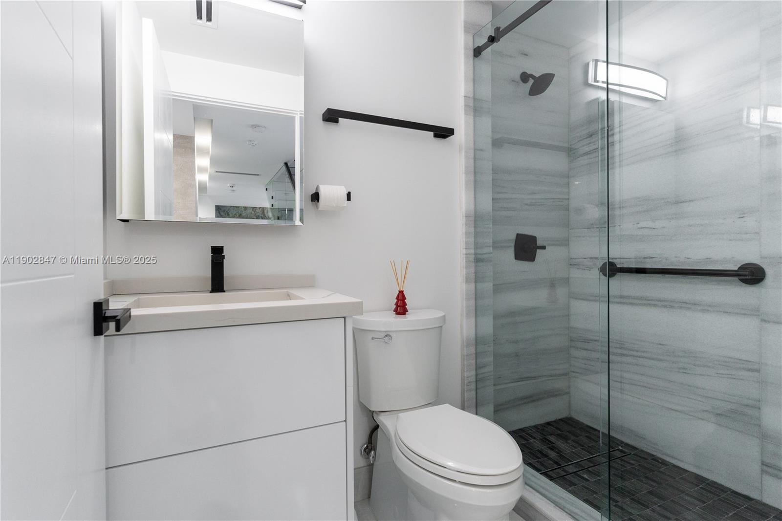 5601 North Ocean Drive Hollywood, FL 33019 - Photo 32 of 78 a bathroom with a toilet sink vanity and shower