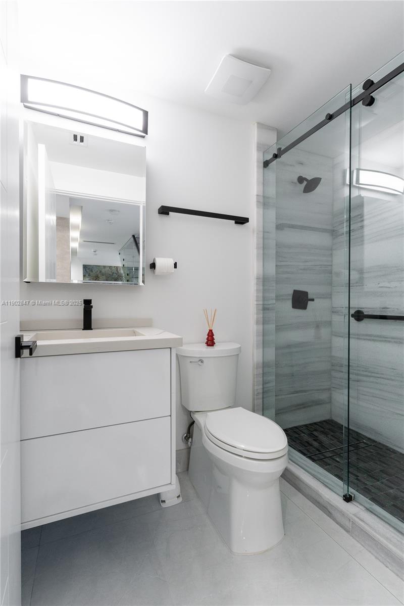 5601 North Ocean Drive Hollywood, FL 33019 - Photo 33 of 78 a bathroom with a toilet sink vanity and shower