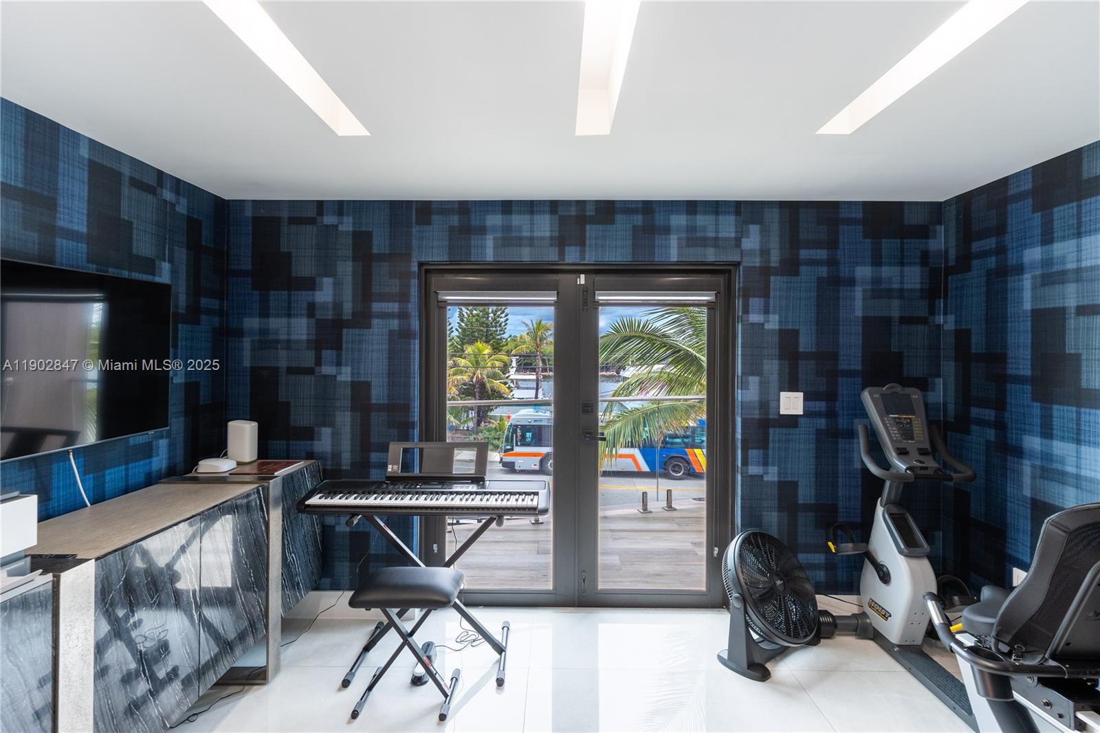 5601 North Ocean Drive Hollywood, FL 33019 - Photo 42 of 78 a work room with furniture and a flat screen tv