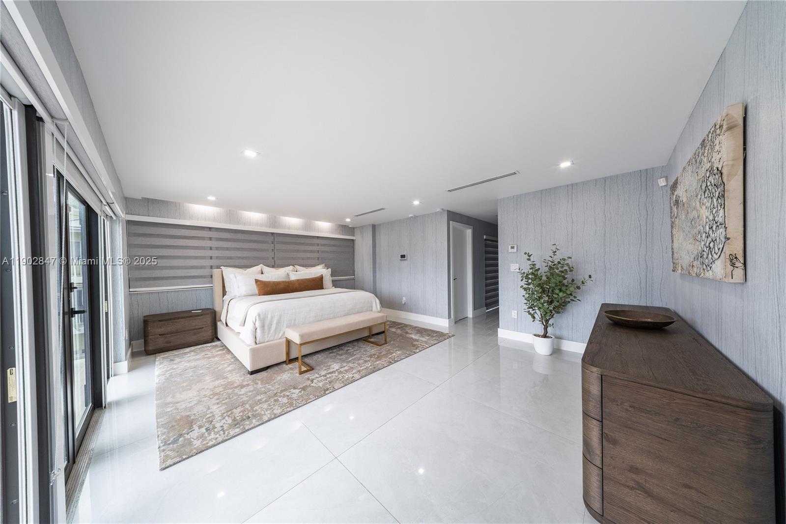 5601 North Ocean Drive Hollywood, FL 33019 - Photo 49 of 78 a spacious bedroom with a large bed and a couch