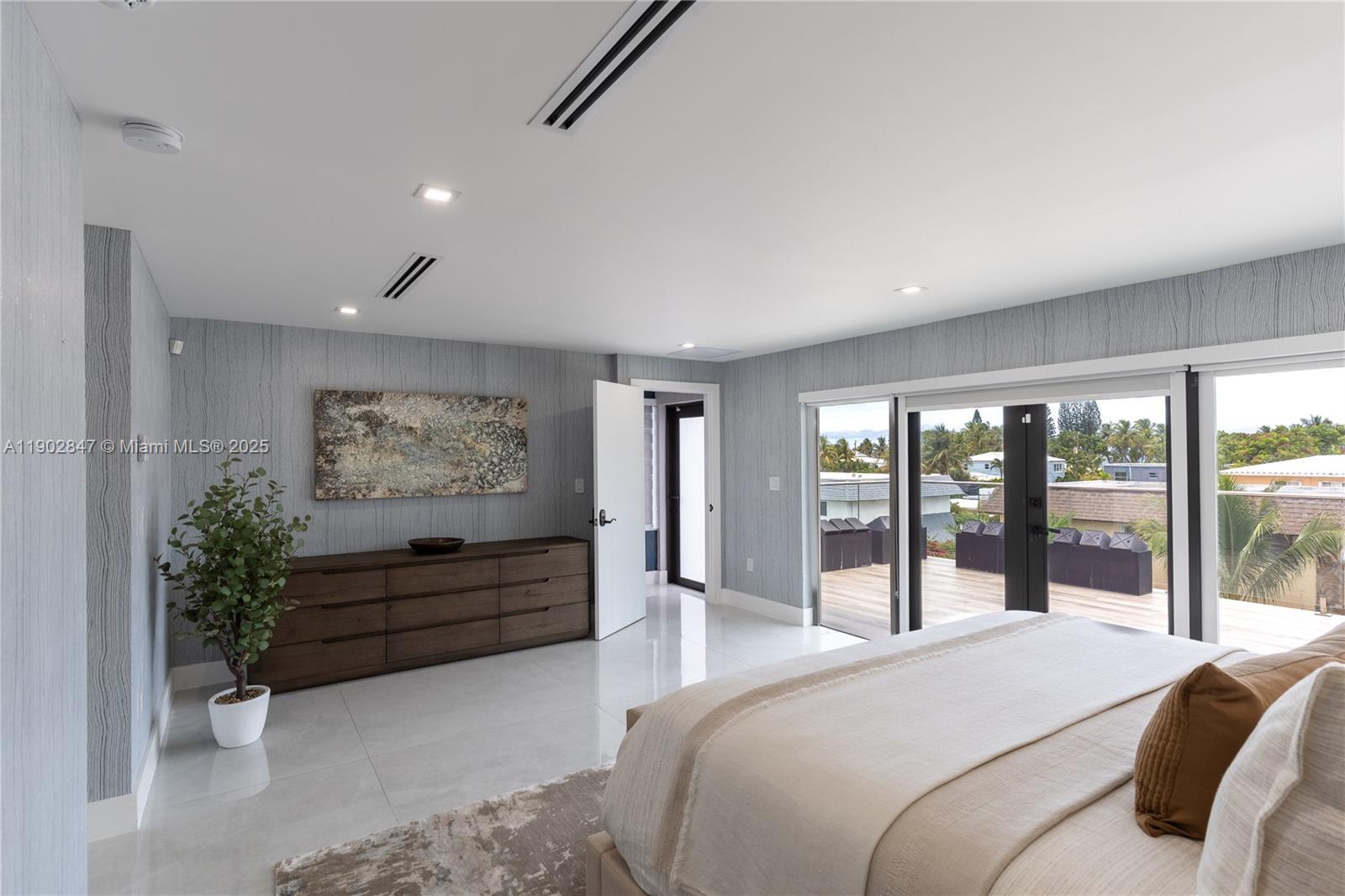 5601 North Ocean Drive Hollywood, FL 33019 - Photo 50 of 78 a bedroom with a bed and a painting on the wall