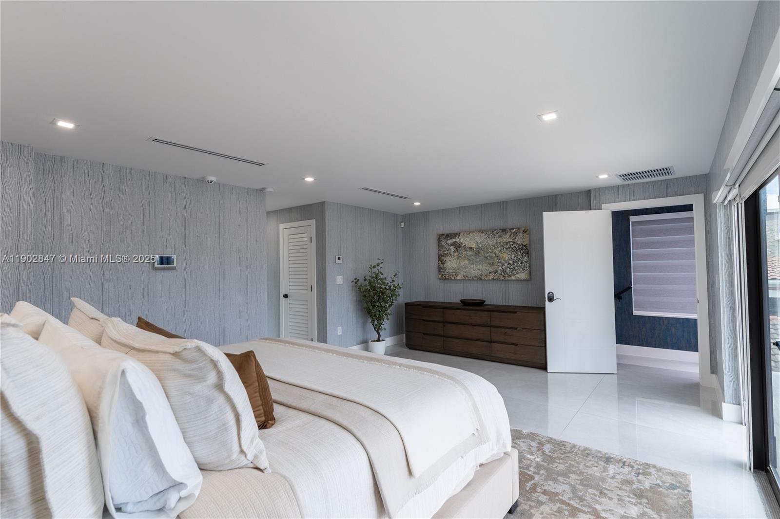 5601 North Ocean Drive Hollywood, FL 33019 - Photo 51 of 78 a bedroom with a bed and glass door