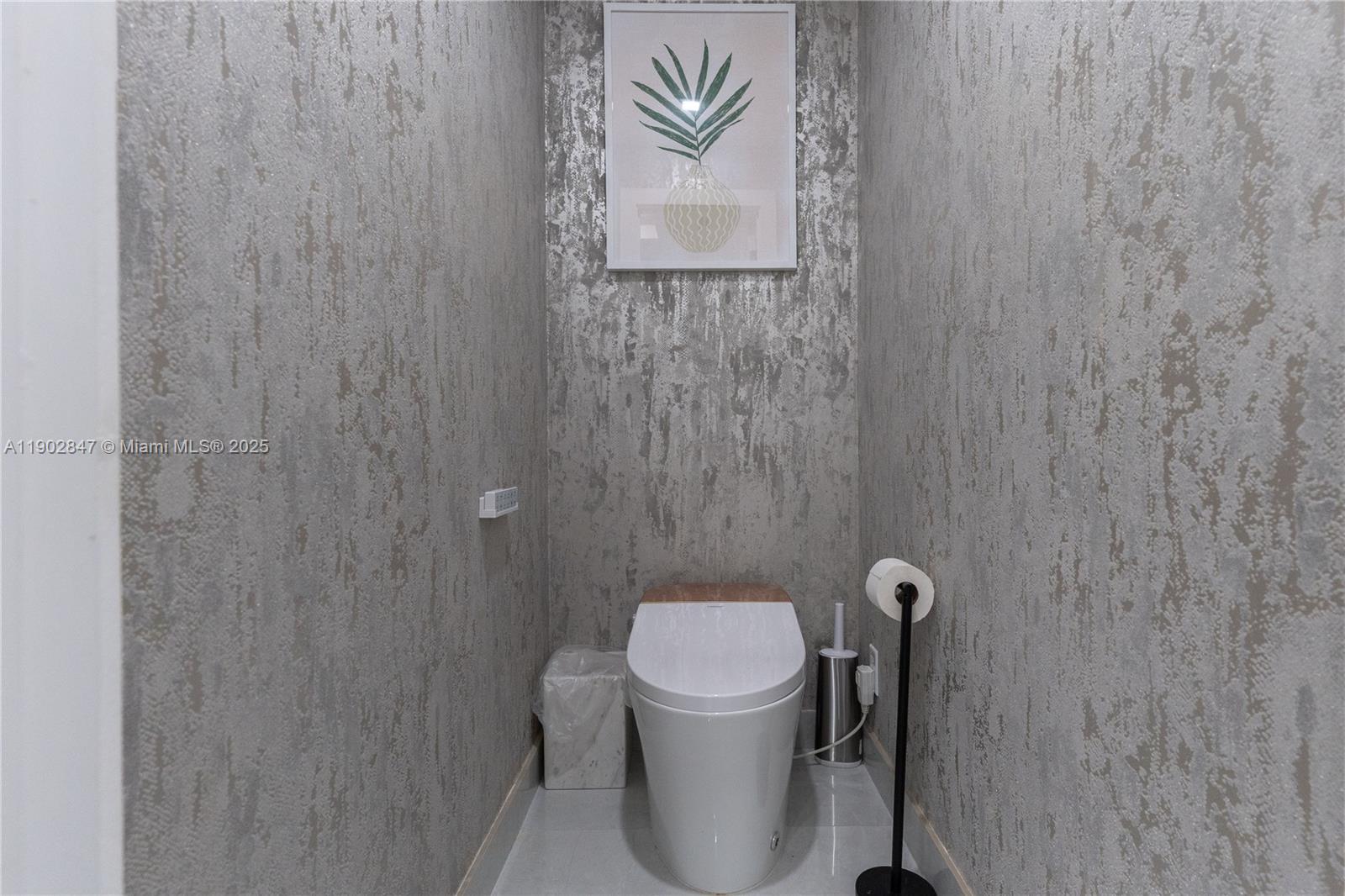 5601 North Ocean Drive Hollywood, FL 33019 - Photo 54 of 78 a bathroom with a toilet and a shower curtain