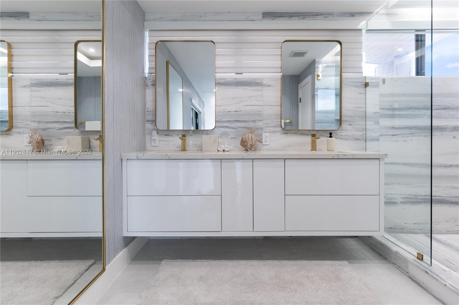 5601 North Ocean Drive Hollywood, FL 33019 - Photo 55 of 78 a bathroom with a double vanity sink and mirror