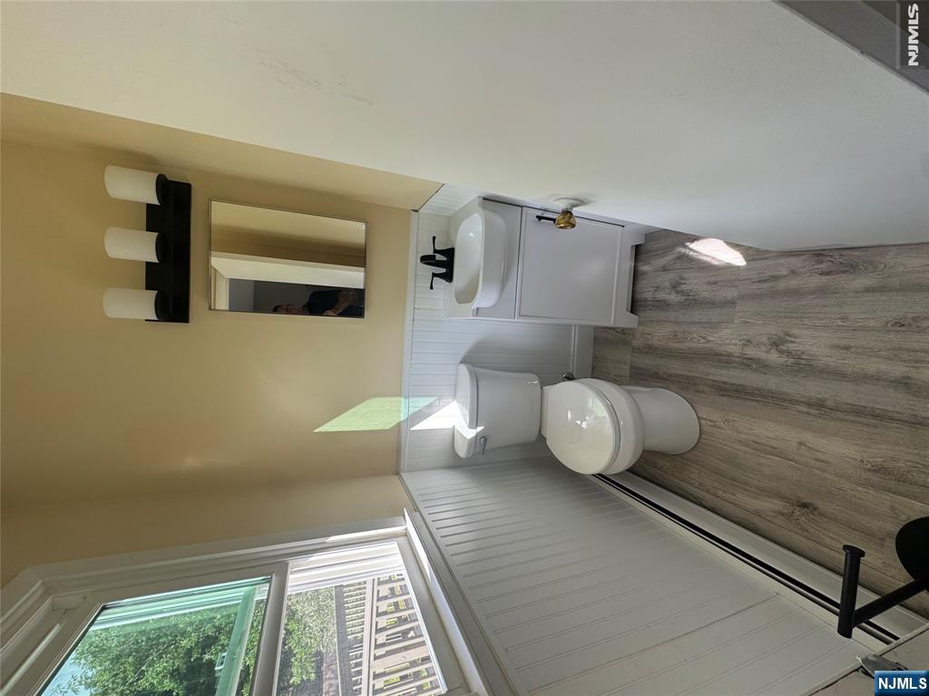 55 Maryann Road Oak Ridge, NJ 07438 - Photo 9 of 20 a bathroom with a toilet sink and mirror