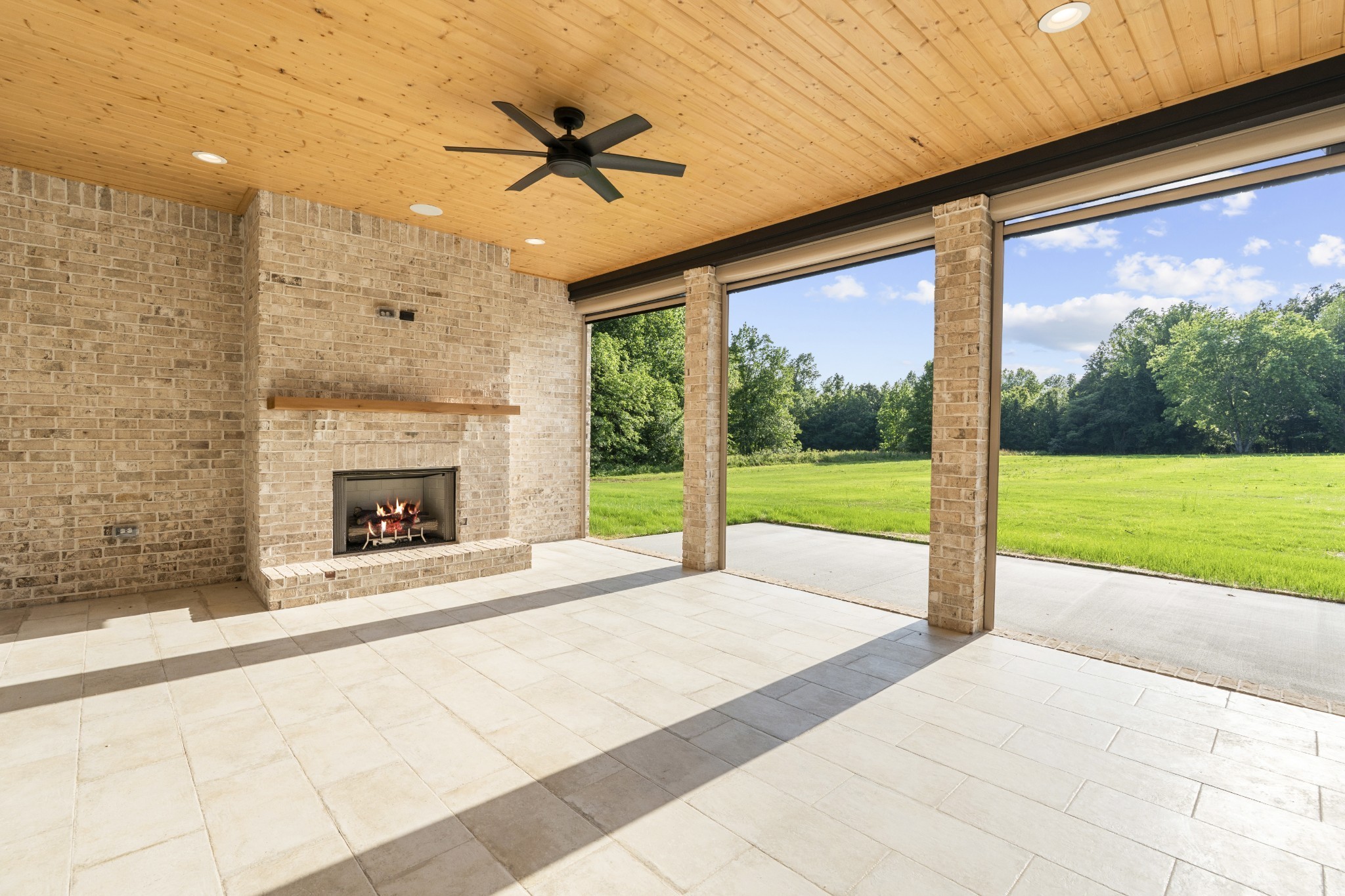 724 Bradshaw Road Lebanon, TN 37087 - Photo 79 of 89 a view of an empty room with a fireplace and a ceiling fan