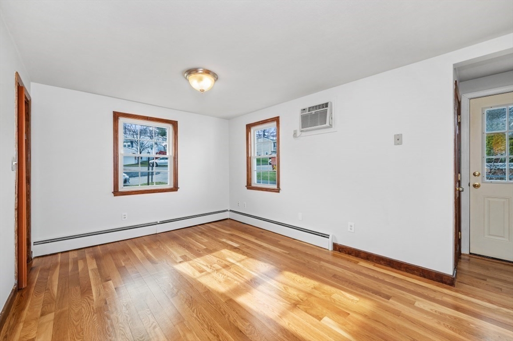 15 Shawmut Road Waltham, MA 02452 - Photo 12 of 40 a view of an empty room with wooden floor and a window
