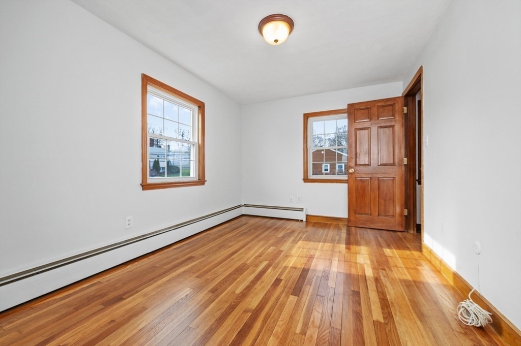15 Shawmut Road Waltham, MA 02452 - Photo 18 of 40 a view of an empty room with wooden floor and a window
