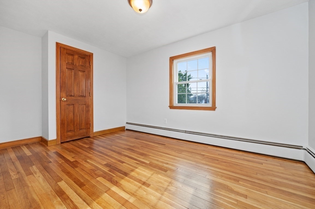 15 Shawmut Road Waltham, MA 02452 - Photo 19 of 40 a view of an empty room with wooden floor and a window