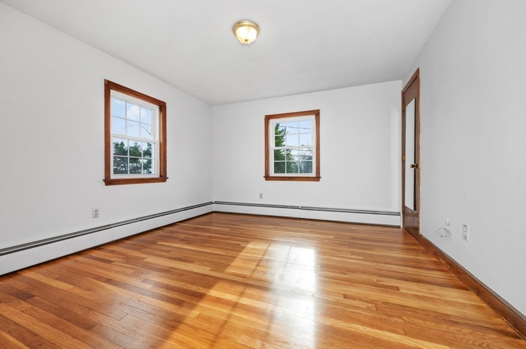 15 Shawmut Road Waltham, MA 02452 - Photo 21 of 40 a view of an empty room with window and wooden floor