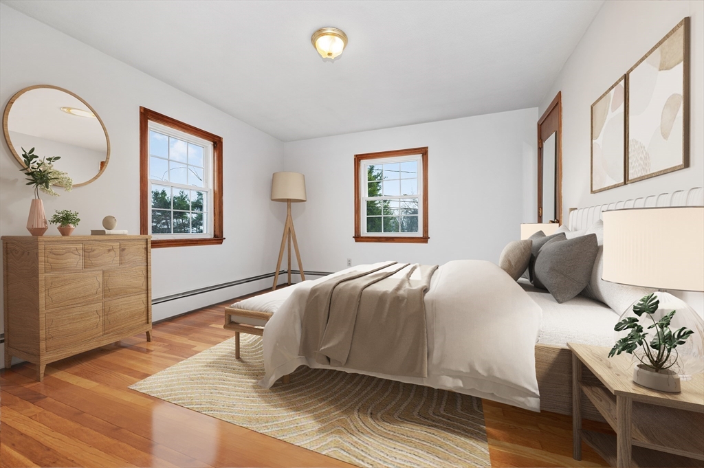 15 Shawmut Road Waltham, MA 02452 - Photo 22 of 40 a bedroom with a bed and wooden floor