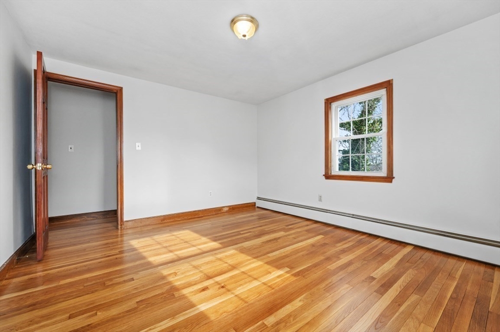 15 Shawmut Road Waltham, MA 02452 - Photo 23 of 40 a view of an empty room with wooden floor and a window