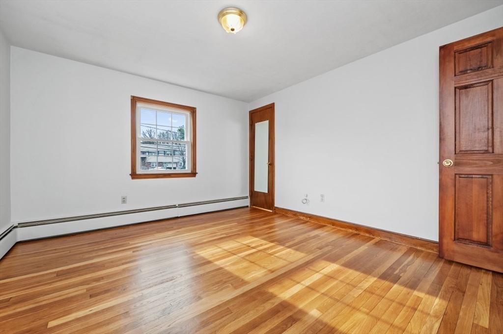 15 Shawmut Road Waltham, MA 02452 - Photo 24 of 40 a view of an empty room with wooden floor and a window