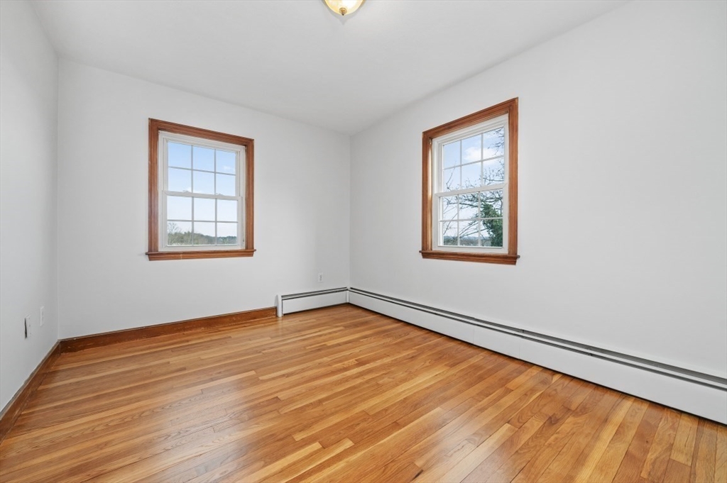 15 Shawmut Road Waltham, MA 02452 - Photo 25 of 40 a view of an empty room with wooden floor and a window