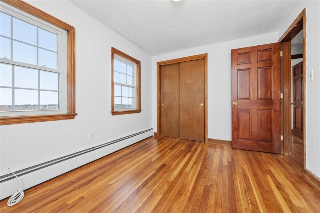 15 Shawmut Road Waltham, MA 02452 - Photo 28 of 40 a view of an empty room with wooden floor and a window