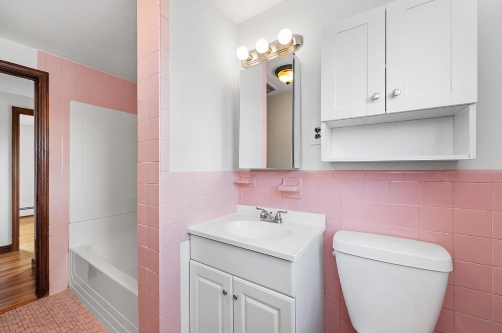 15 Shawmut Road Waltham, MA 02452 - Photo 30 of 40 a bathroom with a toilet sink and mirror