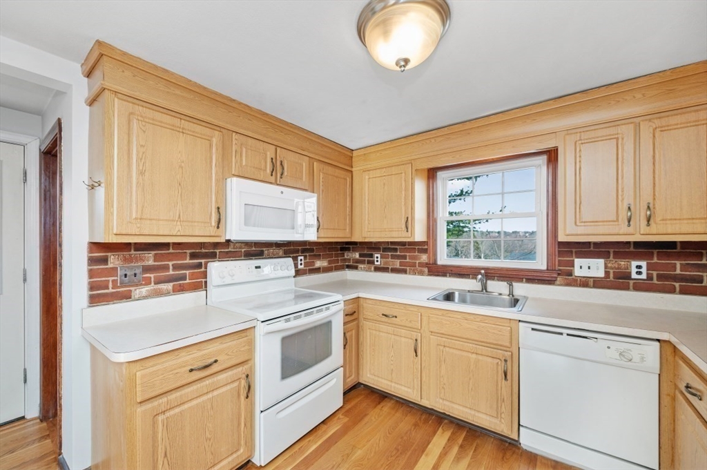 15 Shawmut Road Waltham, MA 02452 - Photo 3 of 40 a kitchen with a sink cabinets appliances and a window