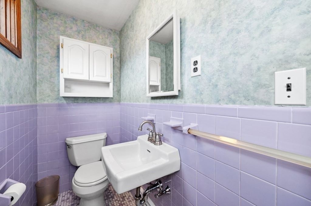 15 Shawmut Road Waltham, MA 02452 - Photo 32 of 40 a bathroom with a sink a toilet and mirror