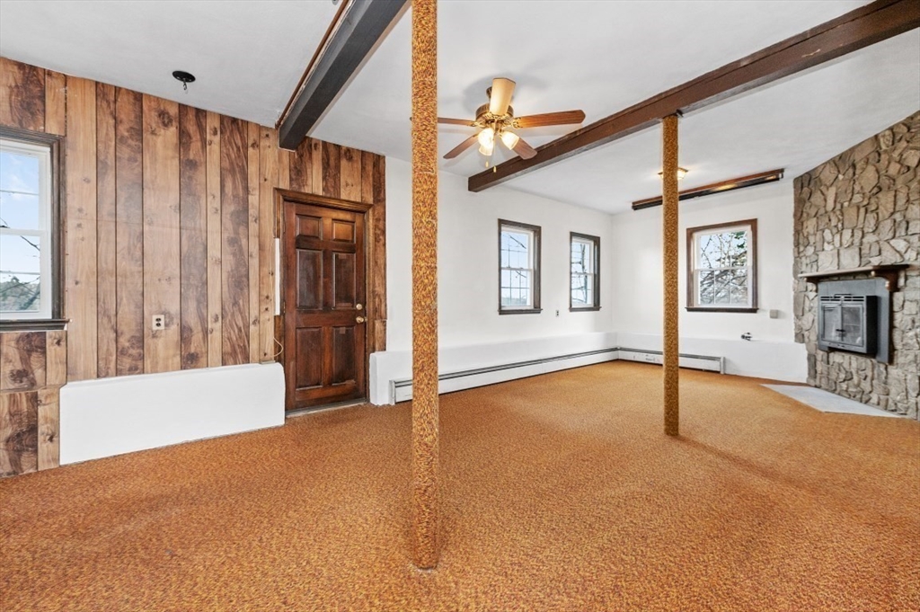 15 Shawmut Road Waltham, MA 02452 - Photo 34 of 40 a view of an empty room with a fireplace and a window