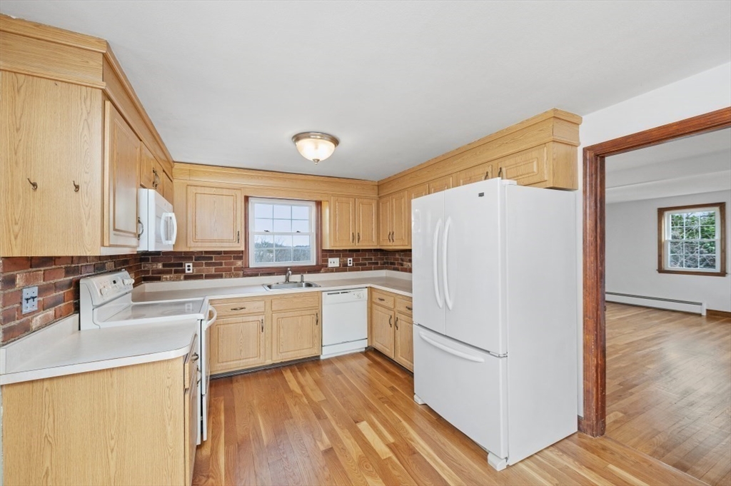15 Shawmut Road Waltham, MA 02452 - Photo 4 of 40 a kitchen with a refrigerator a sink and cabinets