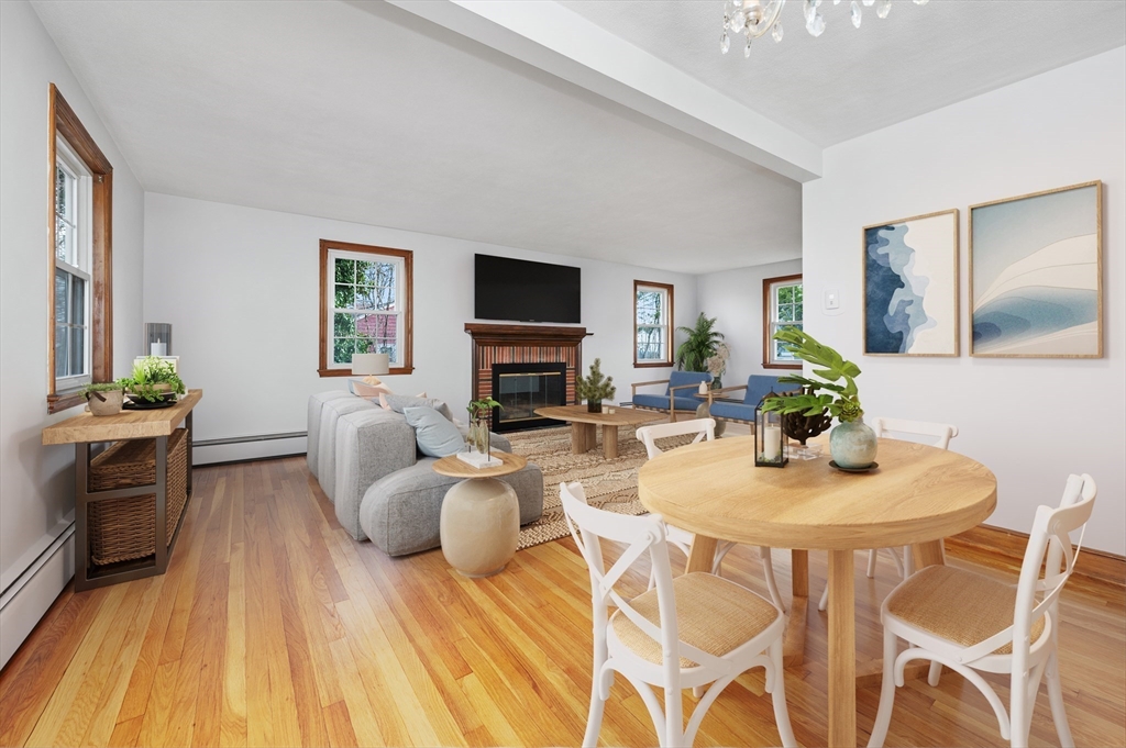15 Shawmut Road Waltham, MA 02452 - Photo 9 of 40 a living room with furniture a flat screen tv and a fireplace