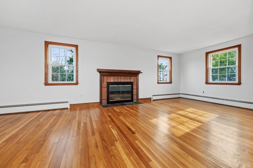 15 Shawmut Road Waltham, MA 02452 - Photo 10 of 40 a view of an empty room with a window and fire place