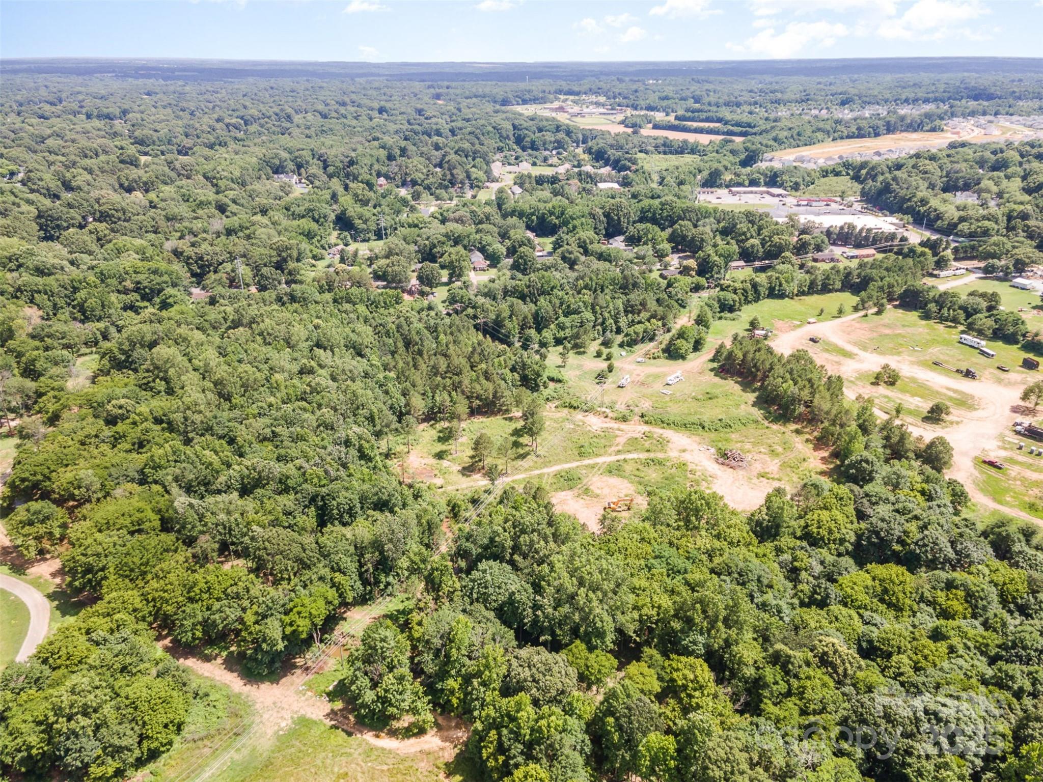 0 Labon Street Monroe, NC 28110 - Photo 5 of 7 an aerial view of a houses with a lush green hillside
