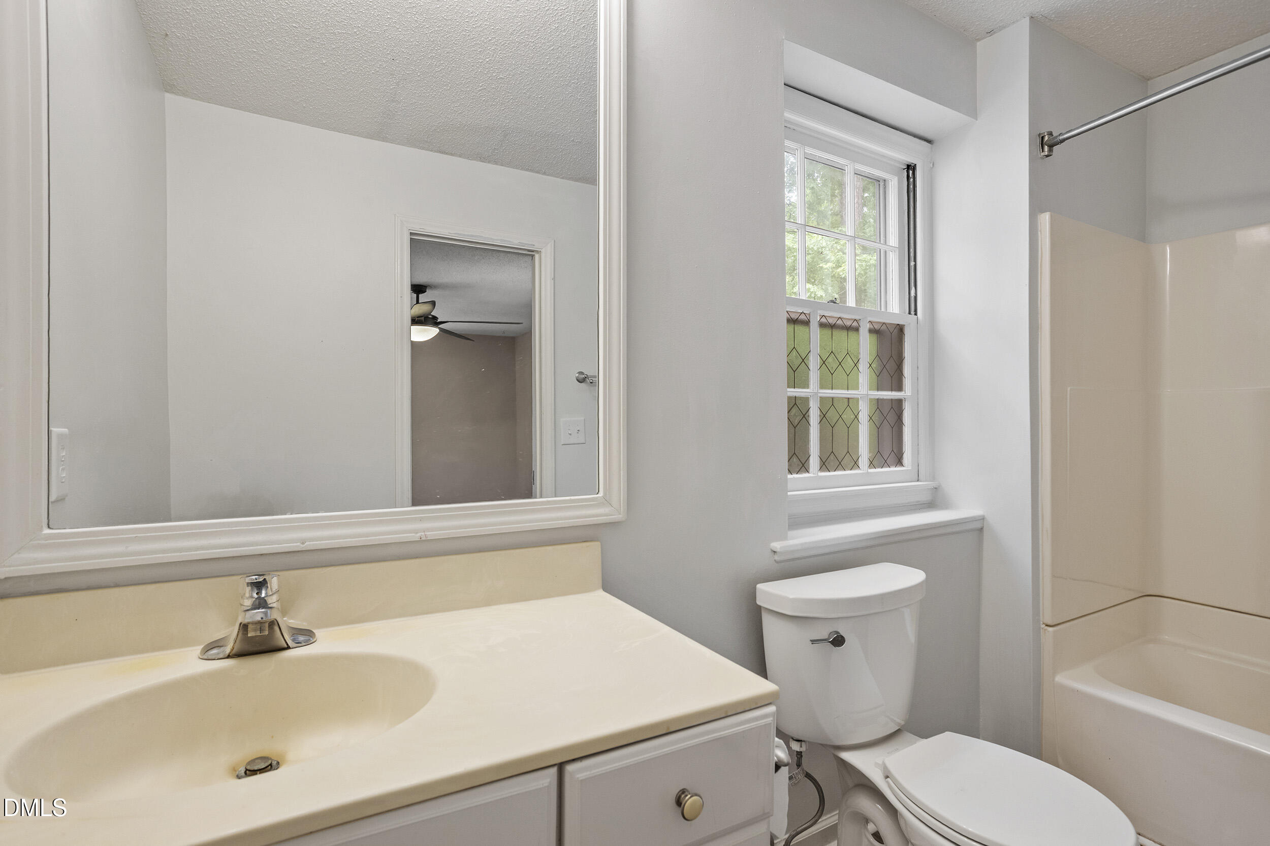 1801 Quail Ridge Road Raleigh, NC 27609 - Photo 18 of 29 a bathroom with a sink toilet a mirror and shower