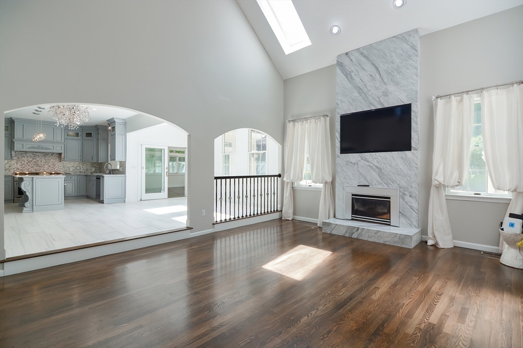 23 Newell Drive Franklin, MA 02038 - Photo 13 of 35 a view of a livingroom with furniture wooden floor and a fireplace