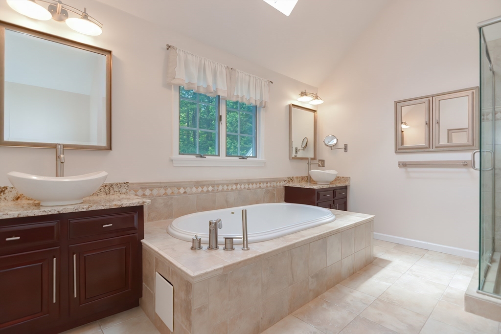 23 Newell Drive Franklin, MA 02038 - Photo 20 of 35 a bathroom with a tub sink and mirror