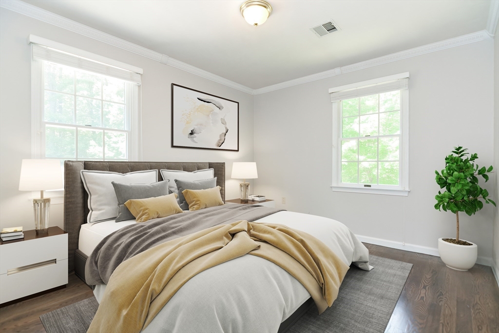 23 Newell Drive Franklin, MA 02038 - Photo 23 of 35 a bedroom with a bed and a potted plant