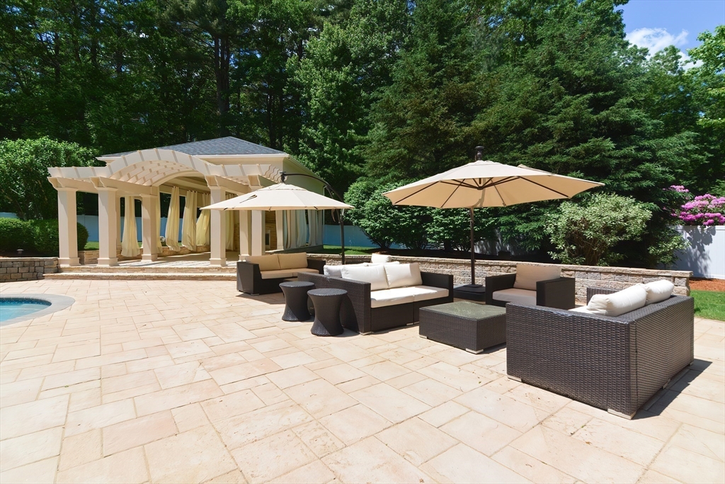 23 Newell Drive Franklin, MA 02038 - Photo 7 of 35 a view of a patio with chairs and a umbrella