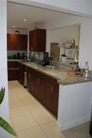 a kitchen with sink and cabinets