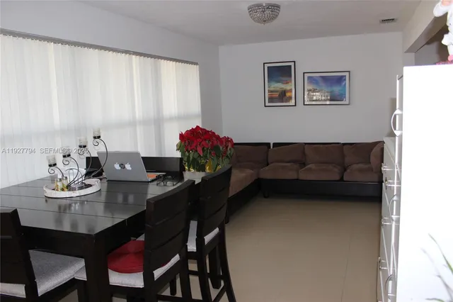 a view of a dining room with furniture and window