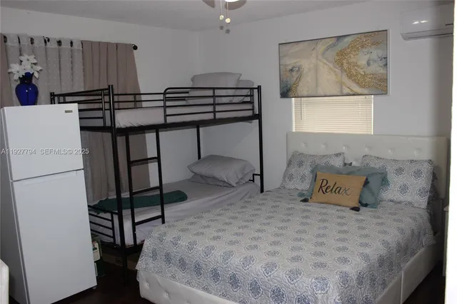 a view of kitchen with furniture and a refrigerator