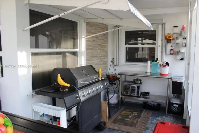 a view of a chairs and table in the back yard of the house