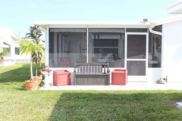 a outdoor view with a fireplace and potted plants