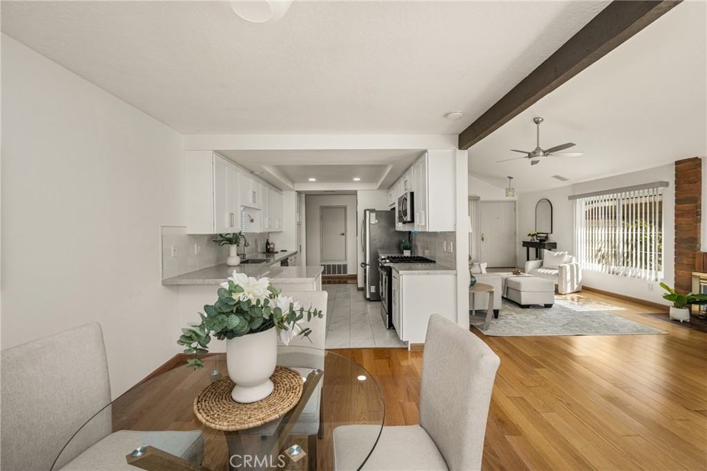 6 Whitecloud Irvine, CA 92614 - Photo 11 of 45 a view of a dining room with furniture a potted plant and wooden floor