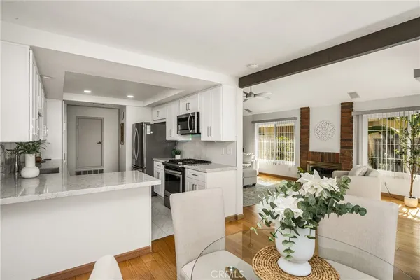 a living room with furniture stove and large window