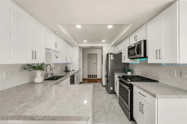a kitchen that has a lot of cabinets in it