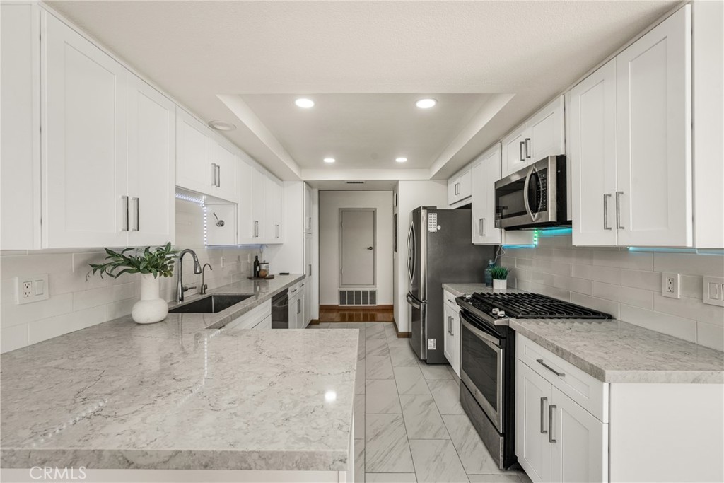 6 Whitecloud Irvine, CA 92614 - Photo 14 of 45 a kitchen that has a lot of cabinets in it